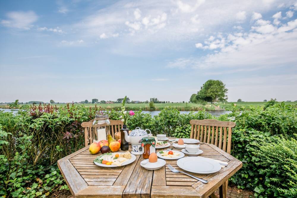 Frühstückstisch am Norder Tief vor den Fährhauslodges Natur in Sicht